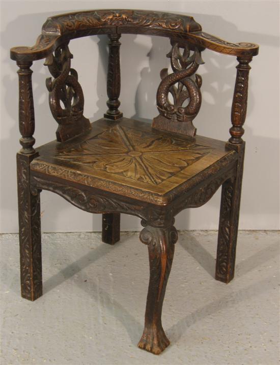 Appraisal: Early twentieth century oak corner chair carved with dolphins masks