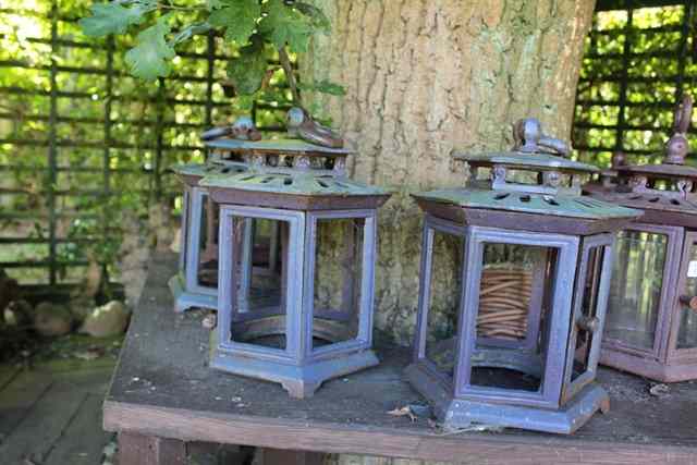 Appraisal: A SET OF SEVEN HEXAGONAL METAL CANDLE LANTERNS with ring