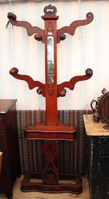 Appraisal: A VICTORIAN MAHOGANY HALL STAND the narrow central mirror flanked