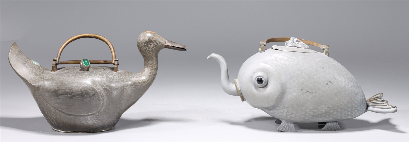 Appraisal: Two old Chinese pewter teapots of fish and duck forms