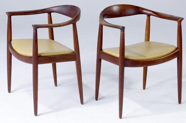 Appraisal: HANS WEGNER Pair of teak armchairs with yellow vinyl cushions