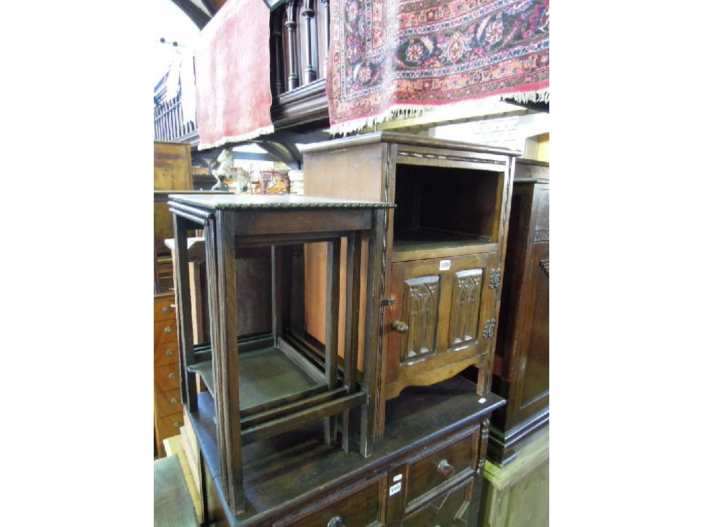 Appraisal: An oak bedside cupboard partially enclosed by a panelled door