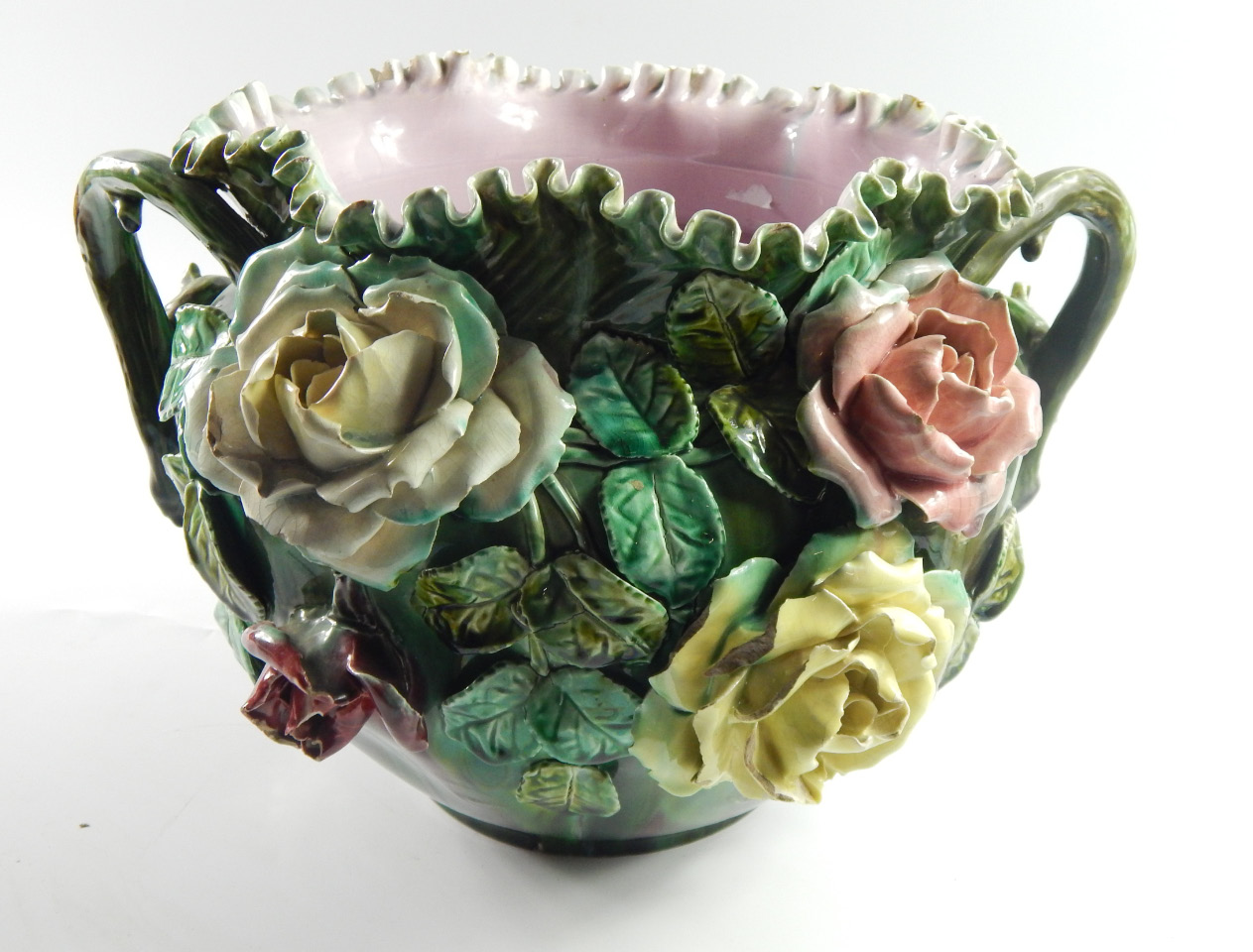 Appraisal: A thC Continental majolica jardiniere encrusted with roses and with