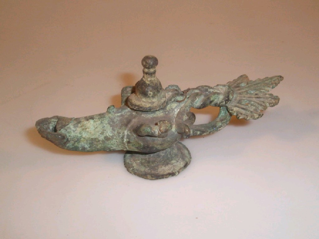 Appraisal: A Roman cast bronze footed oil-lamp with lid plaited handle