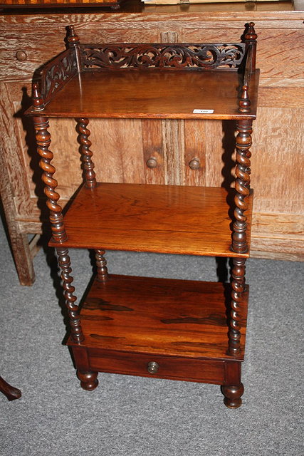 Appraisal: A VICTORIAN ROSEWOOD THREE TIER WHATNOT with fretwork top and