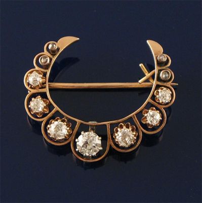 Appraisal: A gold crescent brooch set with graduated circular cut diamonds