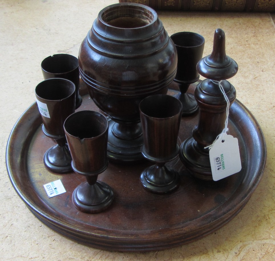 Appraisal: An th century lignum vitae turned decanter cm high together