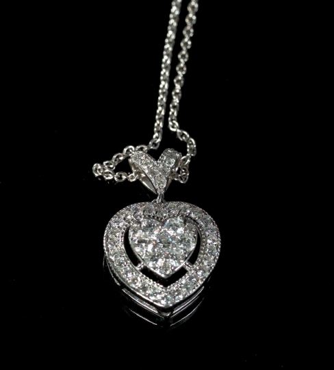 Appraisal: Fourteen-Karat White Gold and Diamond Pendant Heart Necklace composed of