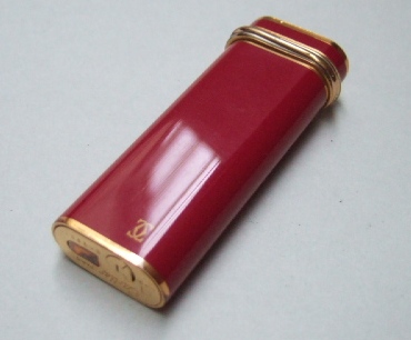 Appraisal: A gilt metal Cartier Paris curved rectangular gas lighter with