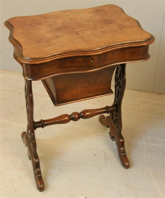 Appraisal: Victorian walnut serpentine work table with central lift-out section revealing