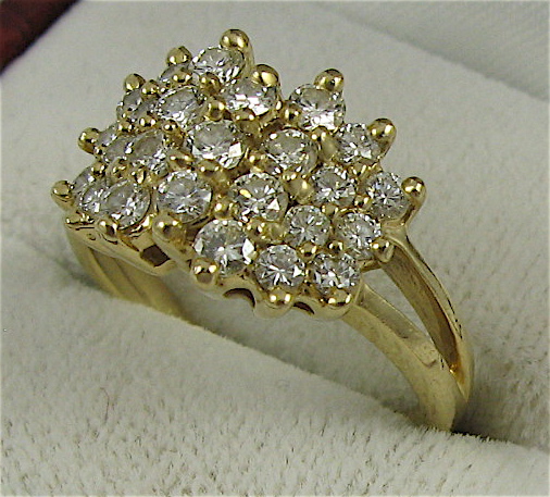 Appraisal: DIAMOND AND K GOLD CLUSTER RING set with round-cut diamonds