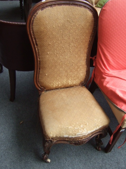 Appraisal: A Victorian walnut high back nursing chair with pierced crest