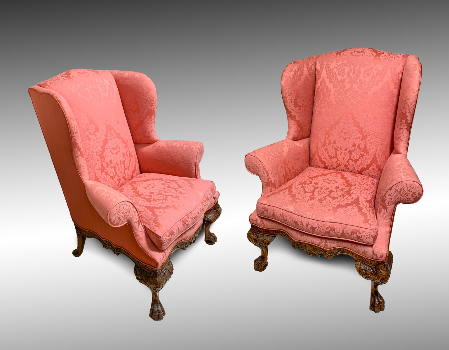 Appraisal: PR HIGHLY CARVED WINGBACK CHAIRS Ornately carved wingback chairs upholstered