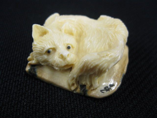 Appraisal: Carved Ivory Netsuke of a Reclining Cat onyx eyes signed