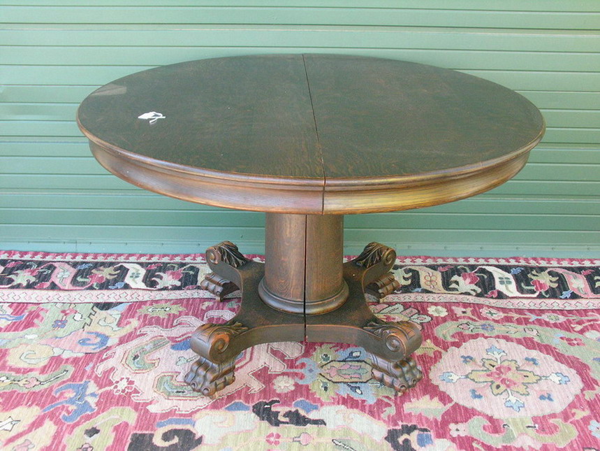 Appraisal: AMERICAN CARVED ROUND OAK TABLE Split pedestal with leaves Size