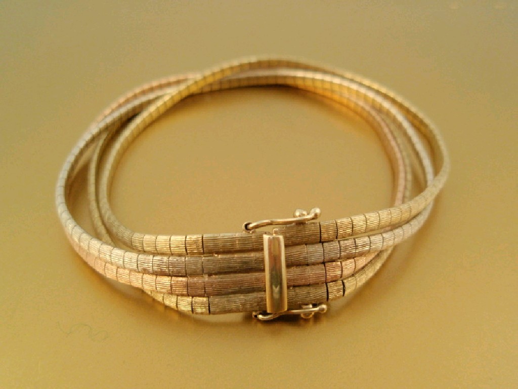 Appraisal: A tri-colour ct gold four strand bracelet import marks g