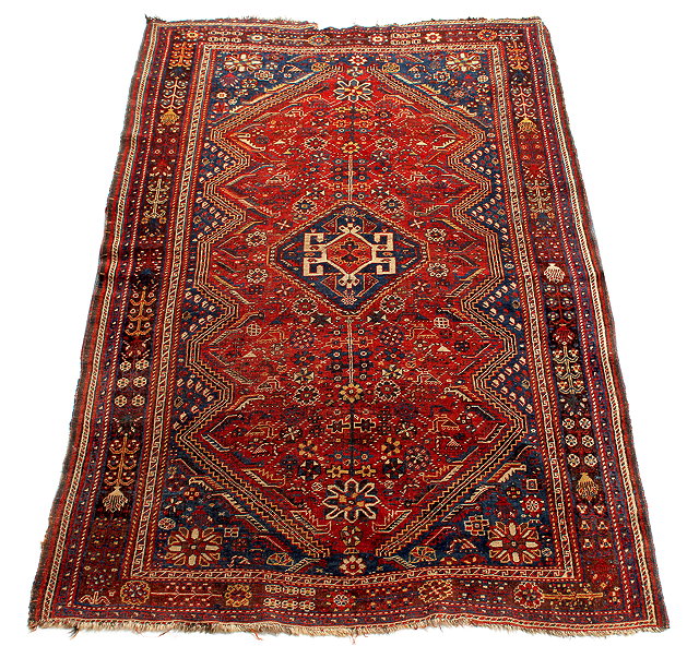 Appraisal: A QASHQAI DARK RED GROUND RUG with a central hooked