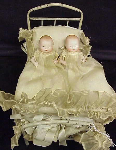 Appraisal: Dolls two all bisque By-Lo babies in cradle presentation all