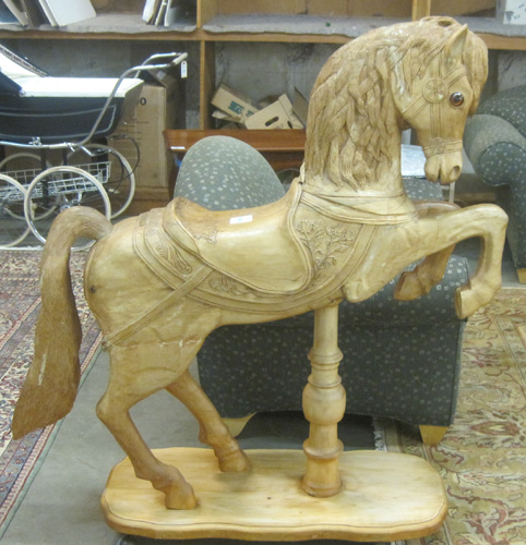 Appraisal: CARVED AND UNPAINTED WOOD CAROUSEL HORSE ON STAND O S