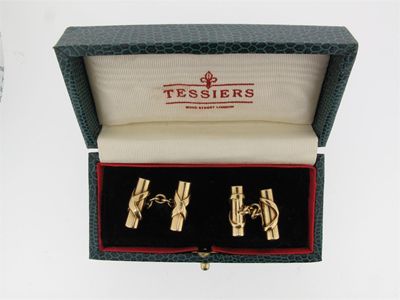 Appraisal: A pair of gold tied baton form cuff links With