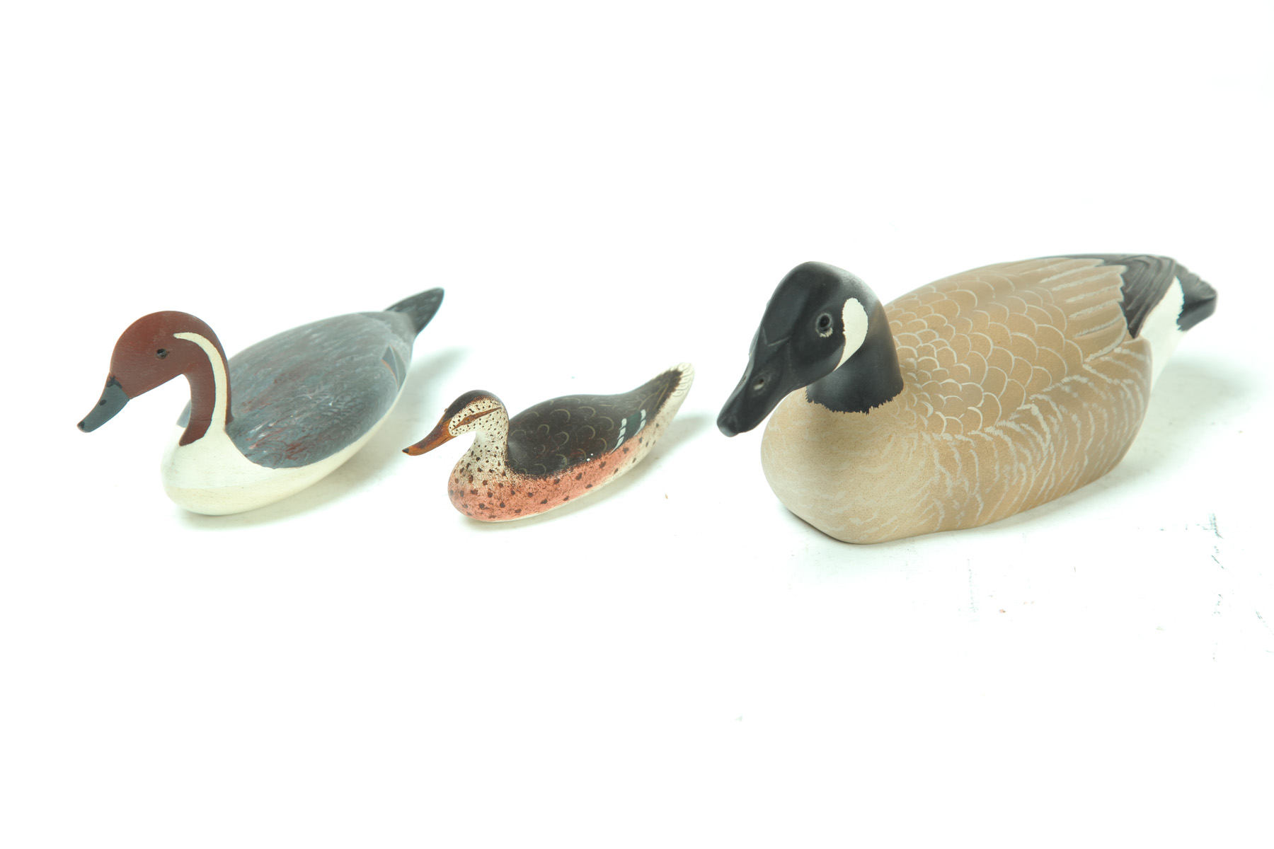 Appraisal: THREE MINIATURE DUCK CARVINGS American nd half- th century Original