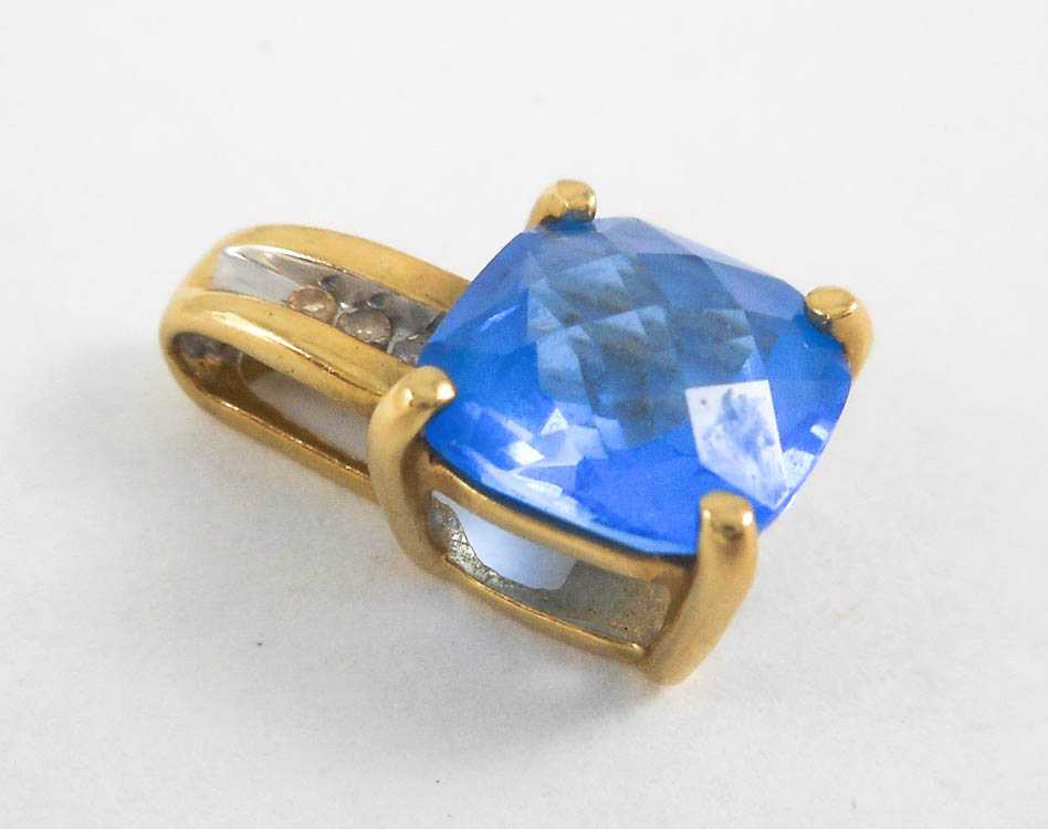 Appraisal: BLUE TOPAZ DIAMOND AND FOURTEEN KARAT GOLD PENDANT with three