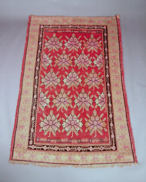 Appraisal: A Khotan carpet the brick red field with rows of