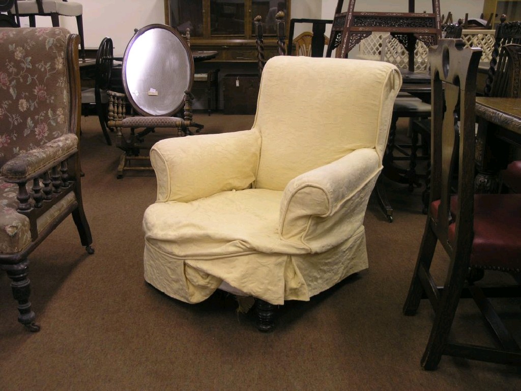 Appraisal: A Victorian upholstered armchair on front turned walnut legs