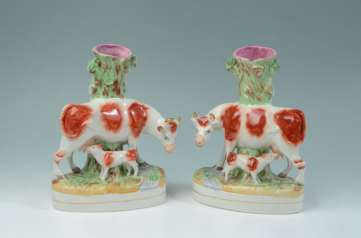 Appraisal: PAIR STAFFORDSHIRE FIGURAL COW SPILL VASES Mirror image pair of