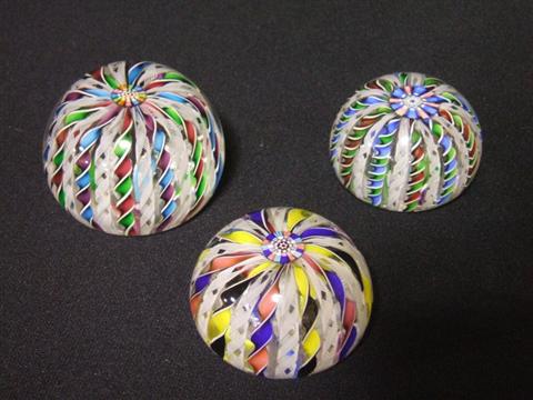 Appraisal: THREE PAPERWEIGHTS Each with latticino spirals radiating from the center