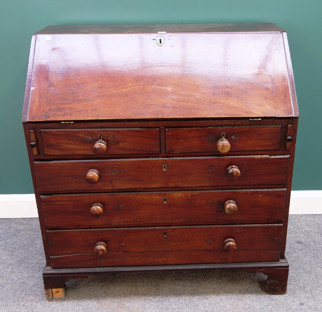 Appraisal: A George III mahogany bureau the fall enclosing a fitted