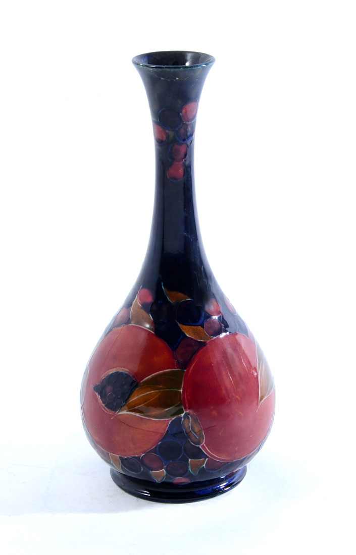 Appraisal: MOORCROFT POTTERY POMEGRANATE BOTTLE VASE Cobalt blue ground pomegranate design