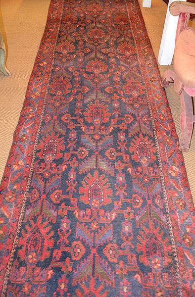 Appraisal: AN AFGHAN FLOOR RUNNER with a central geometric pattern within