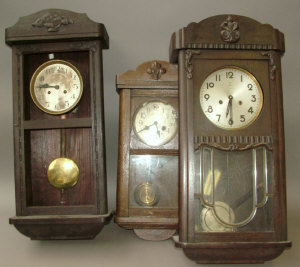 Appraisal: A Continental wooden cased wall clock by Junghans height approx