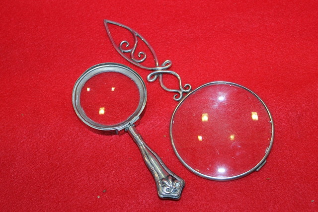 Appraisal: A SILVER MAGNIFYING GLASS with pierced stylised handle Birmingham together