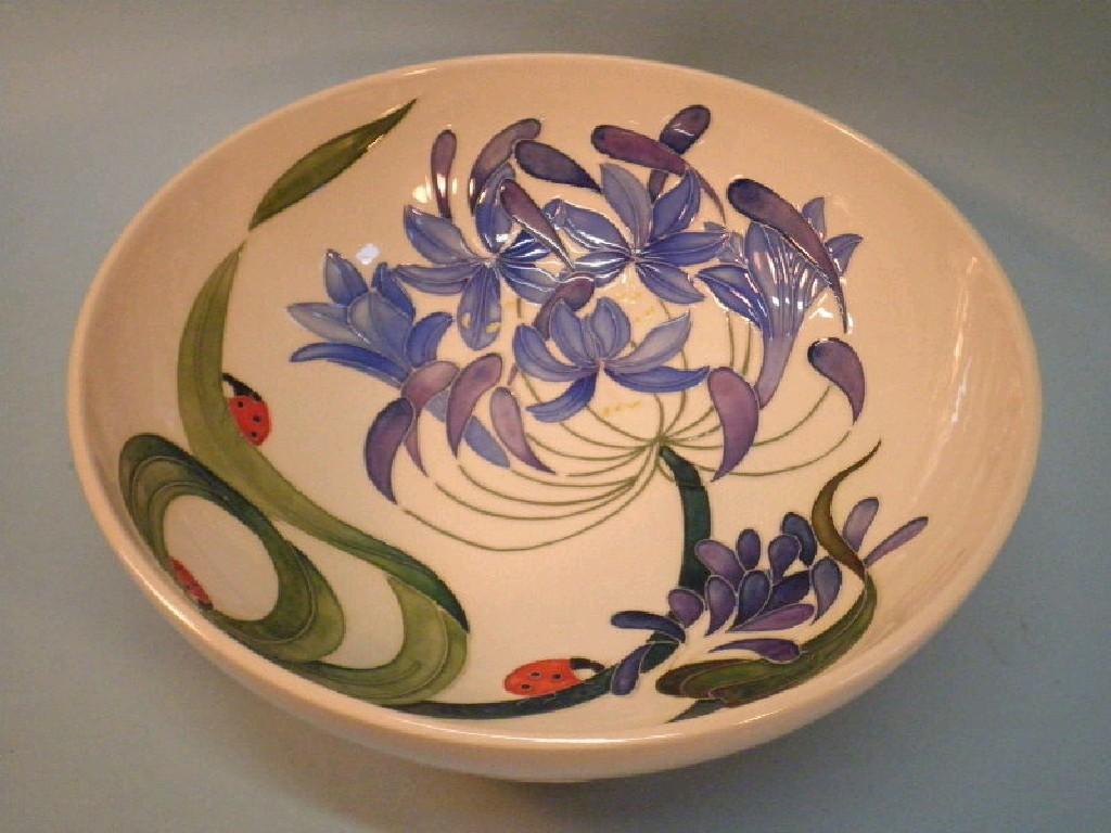 Appraisal: A modern Moorcroft bowl decorated with ladybirds and purple flowers