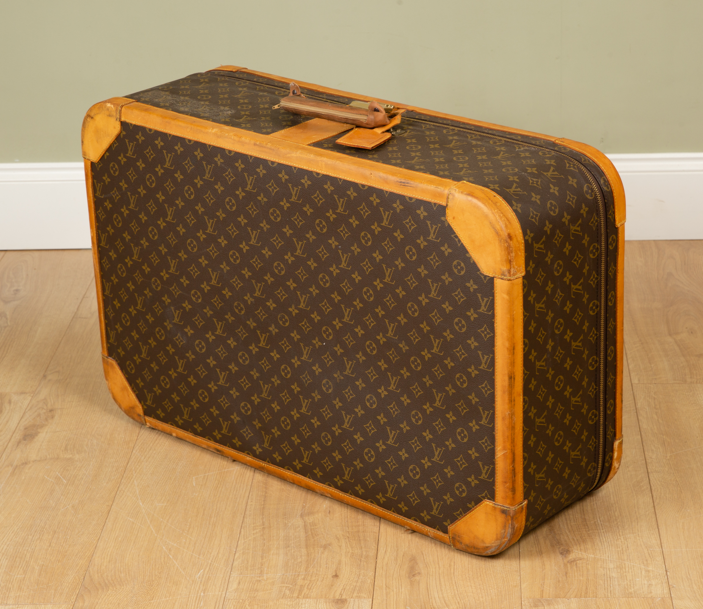 Appraisal: A Vintage Louis Vuitton suitcase with brass clasp and combination