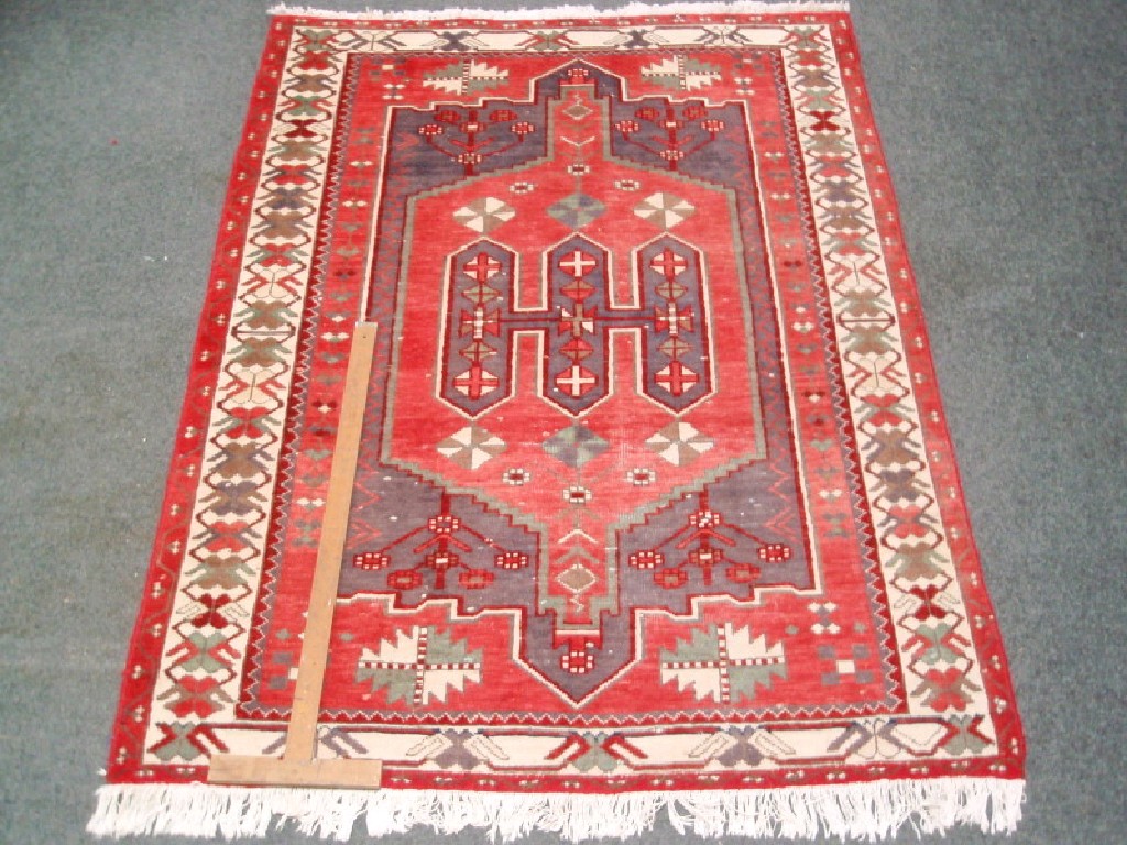 Appraisal: A red ground Tekke style rug cm x cm