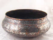 Appraisal: A large th c Islamic copper basin extensively overlaid with