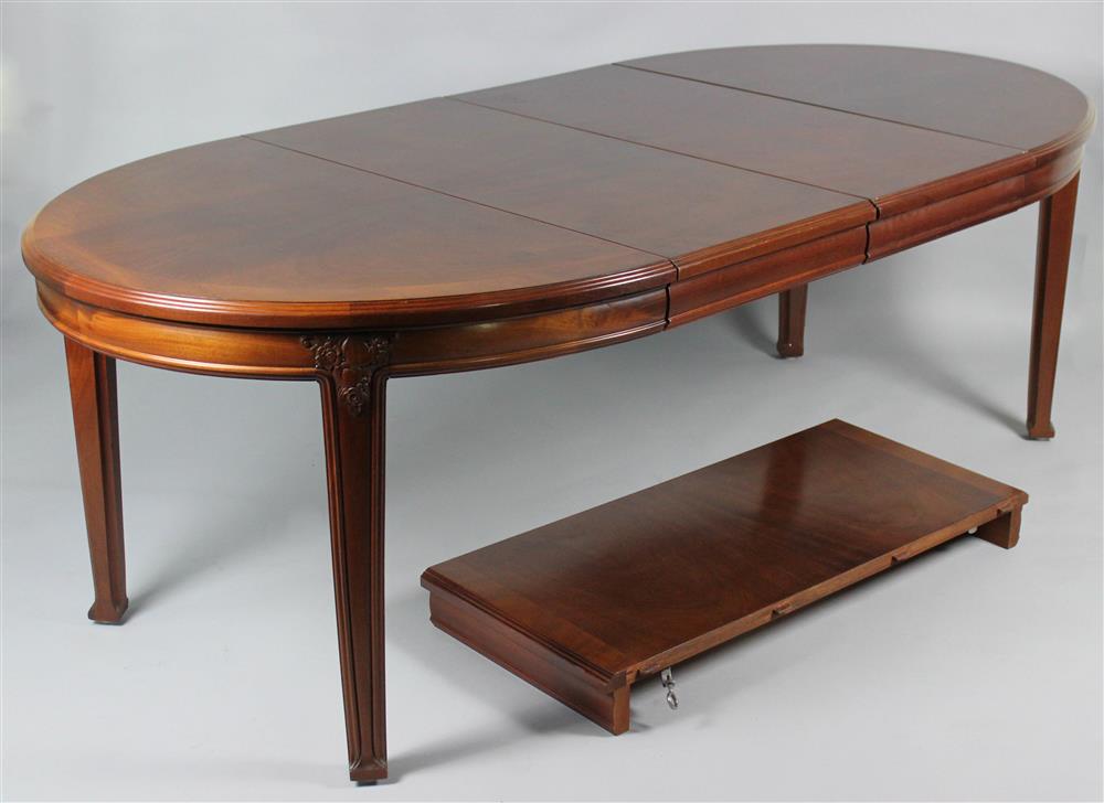 Appraisal: OVAL EXTENDING CARVED MAHOGANY DINING TABLE WITH THREE LEAVES having