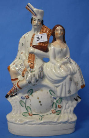 Appraisal: th Century Staffordshire Flatback figure of Scottish Piper and Lady