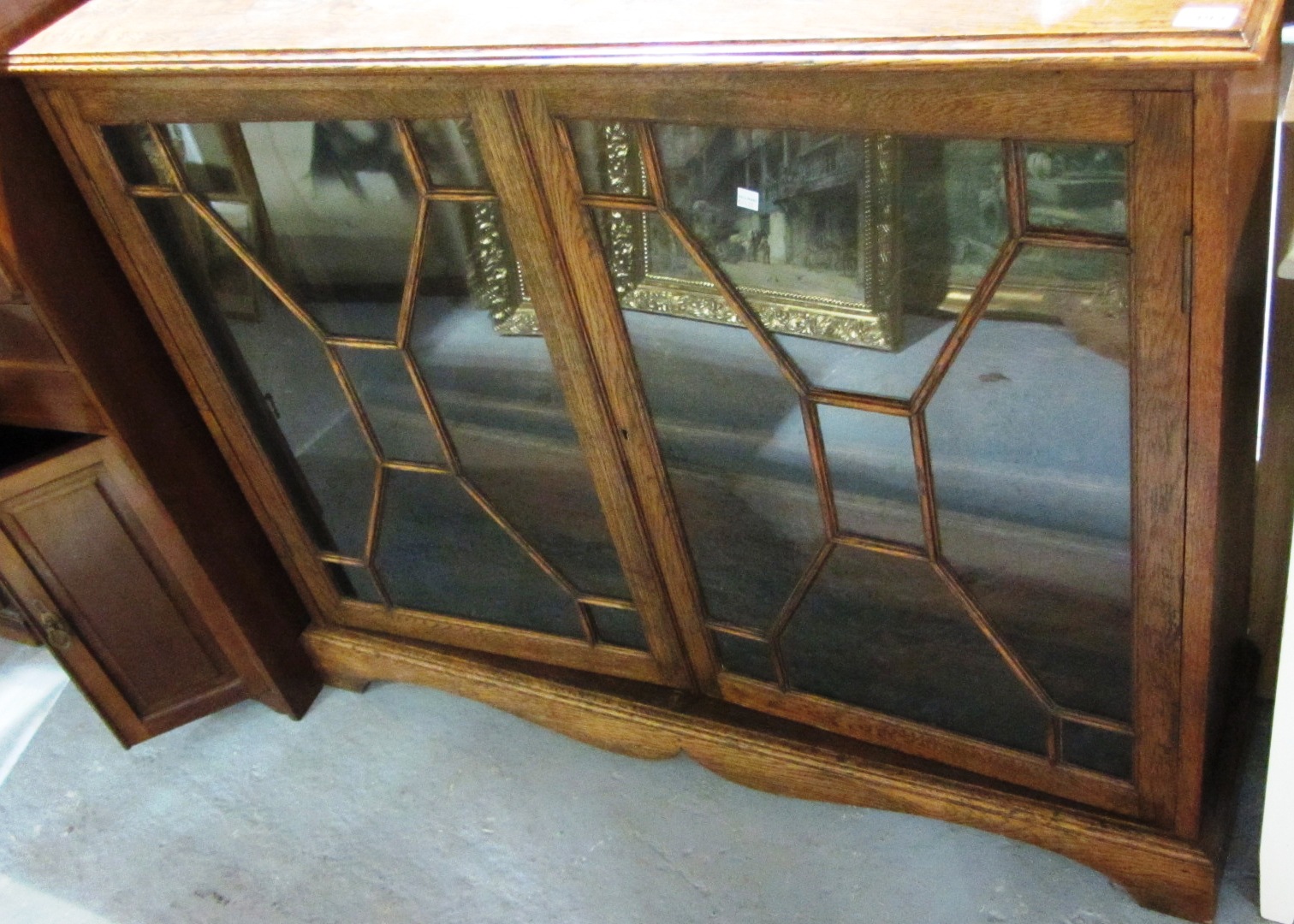 Appraisal: A th century oak bookcase with a pair of leaded