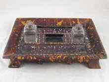 Appraisal: A tortoiseshell double inkstand on four feet with twin cut