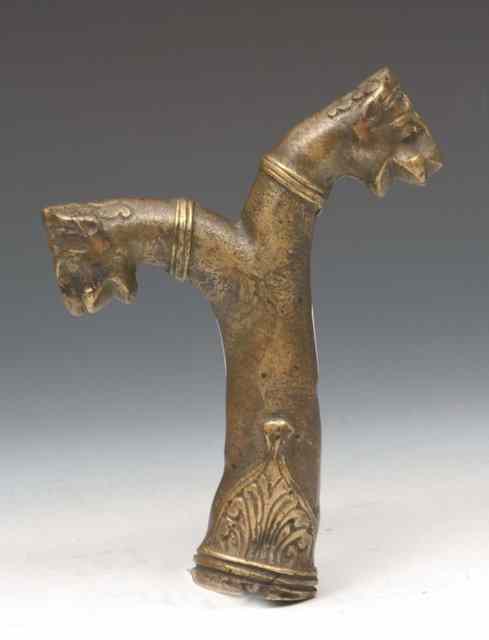 Appraisal: A PERSIAN OR OTTOMAN BRONZE DOUBLE HEADED BRONZE HILT probably