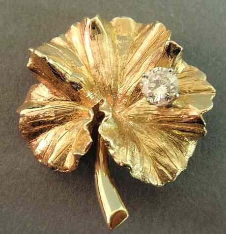 Appraisal: Diamond leaf brooch k yg leaf supporting a round brilliant