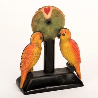 Appraisal: Parrot Trump Indicator Circa Celluloid parrots with paper wheel showing