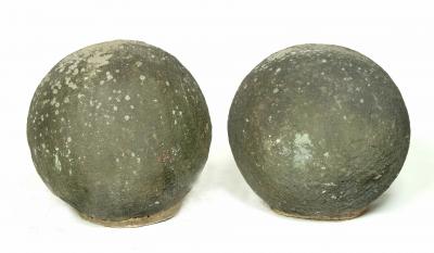 Appraisal: A PAIR OF STONE SPHERES late th th century high