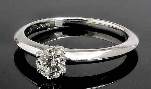 Appraisal: A modern Tiffany platinum mounted solitaire diamond ring the brilliant