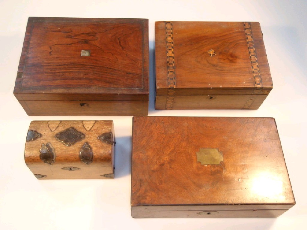 Appraisal: A Victorian mahogany dome top tea caddy with metal mounts