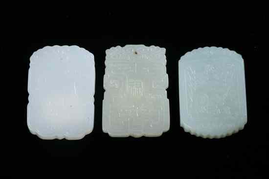 Appraisal: THREE CHINESE WHITE AND CELADON JADE PENDANTS Carved to depict